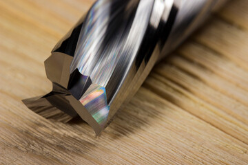 wood processing cutter in close-up on a light wooden background. spiral carbide cutter.