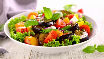 Fresh and Colorful Salad Bowl with Tomatoes, Eggplant, and Basil Leaves on a White Table.