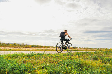 Fototapeta premium Adventure cycling woman riding bike in rural environment