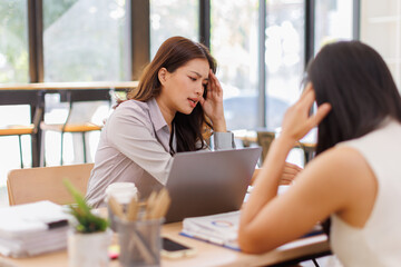 Fototapeta premium Tired team business Asian women work with documents tax laptop computer in office. Sad, unhappy, Worried, Depression, or employee life stress concept 