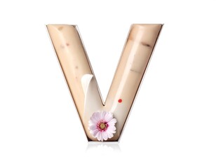 A large, translucent letter V filled with layered light-colored cream and accented with a delicate pink flower