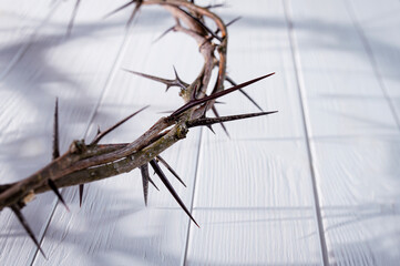 Crown of thorns casting a distinct shadow a white background, creating a symbolic easter image of suffering, sacrifice, and remembrance Copy good space text for friday