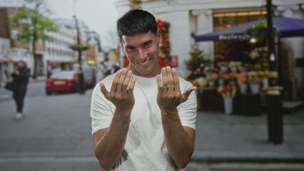 Man beckoning with both hands and smiling while standing on bustling street market outdoors  invitation. © Krakenimages.com