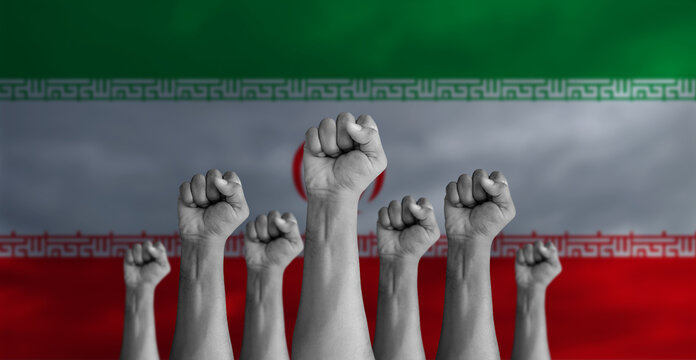 protesters hand with Iran flag painted on the background. Iranian peoples protesting.