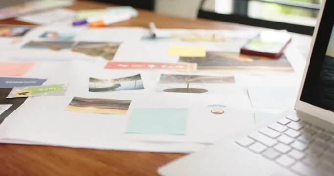 After zooming, camera panning across table revealing laptop, smartphone and planning materials