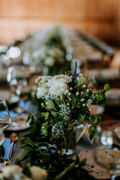 detail of flower arrangements on a dinner table in rustic setting
