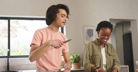 Diverse cooking hosts noticing ring light, chopping vegetables, tasting seasoning during demo