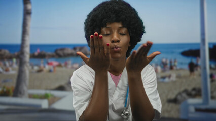 Woman doctor wearing white uniform with stethoscope and afro hairstyle blowing kiss on street; joy.