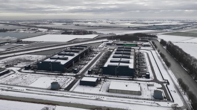 Aerial drone video of a large-scale computing and datacenter facility in winter, showcasing telecommunications infrastructure, server systems, and high-capacity digital operations.