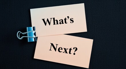 Conceptual Image Displaying 'What's Next?' Question, Representing Future Planning and Decision Making on Dark Fabric Background