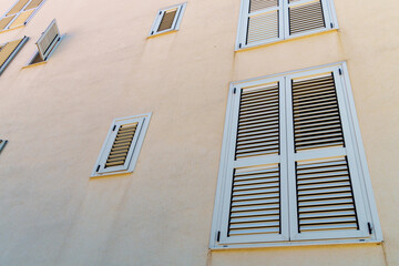 Grey window shutters on beige wall Montenegro