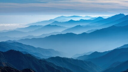 Layered Mountainscape with Blue Hues and Misty Atmosphere, Revealing Depth and Serenity, Ideal for Travel and Nature Themes