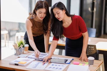 Two business women presenting product sales analytic data to team of colleagues. Professional analysts discussing paper marketing report, brainstorming on project growth strategy
