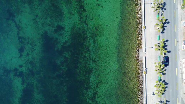Top view aerial drone of lakeside promenade and emerald water in Nyon, Switzerland