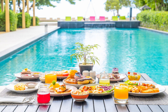 Luxurious brunch spread near poolside setting, featuring vibrant fresh