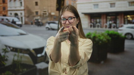 Fototapeta premium Woman with glasses pointing finger at camera on busy city street with parked van; playful confidence.