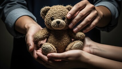 Woman hands holding a small teddy bear, concept of care, childhood, and protection, ideal for parenting or charity initiatives.