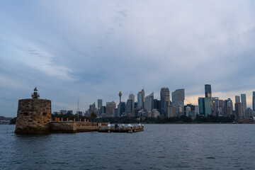 Sydney skyline at sunset with golden reflections on the water