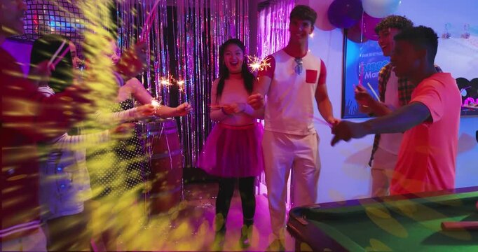 Seven partygoers lighting sparklers, waving them, forming spark-ring overlay, celebrating