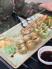 Assorted Sushi Rolls with Wasabi, Ginger and Soy Sauce; Japanese Sushi Platter with Maki Rolls and Dipping Sauce; maki rolls, fried sushi, avocado rolls, sesame topping, wasabi, pickled ginger