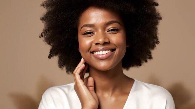 Portrait of a smiling woman with curly hair and clear skin