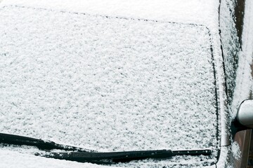 Frozen windshield covered in hoarfrost in winter