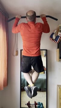 dominadas de calistenia en barra para entrenamiento f&iacute;sico y fuerza en gym de casa con espejo y pesas y mancuerna