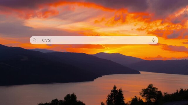 Typing in search bar to find information about CVS. Close up of search box shows the location and activity during sunset near the water and mountains.