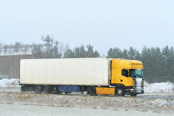 White freight lorry in snowy conditions