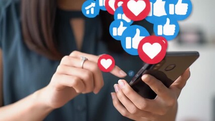 Close-up video: diverse hand on a brand-neutral smartphone, tapping. Animated red heart and blue thumbs-up icons float upwards from screen against soft bokeh. Digital progress concept