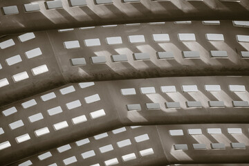 Abstract architecture detail shows perforated concrete pattern with texture and shadow geometry for modern design on an interior surface