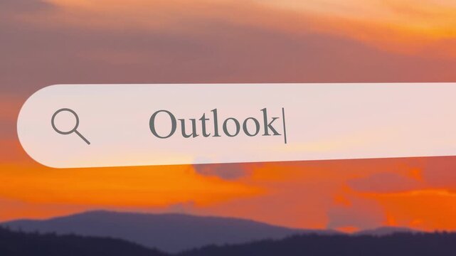Typing the word Outlook in the search box while a sunset view appears in the background with mountains and water below.