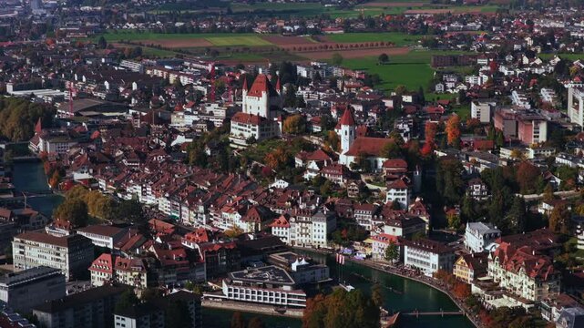 Thun Castle aerial drone view Schloss Thun Thunersee Switzerland Schweiz Europe Autumn Fall Aare River pedestrian walkway blue sky clouds sunny yellow birches tree Bernese Oberland circle left motion