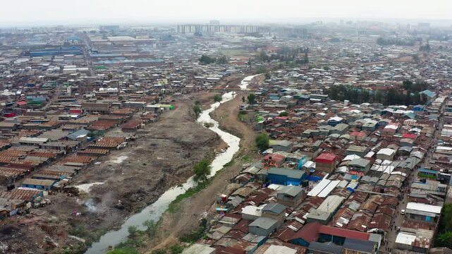 Aerial drone footage of the Kibera Mukuru slum in Nairobi with its polluted river and rusty shacks