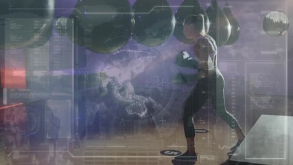 Animation of data processing over caucasian female boxer punching at gym - Powered by Adobe