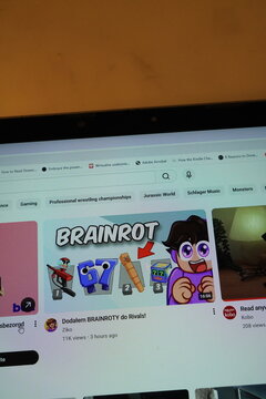 YouTube interface with "BRAINROT" video thumbnail and search bar visible