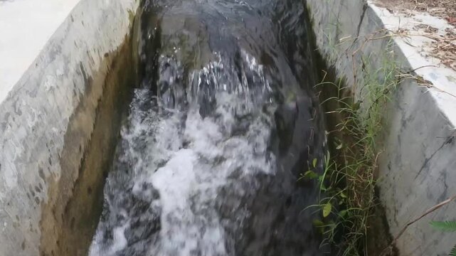The ripples of water in an irrigation channel