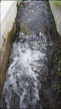 The ripples of water in an irrigation channel