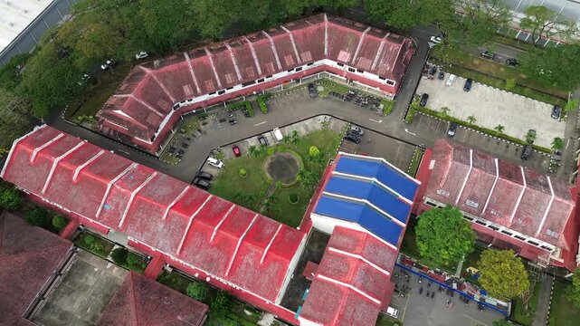 Aerial footage taken using a drone shows bright red and striking blue roofs all over the building.