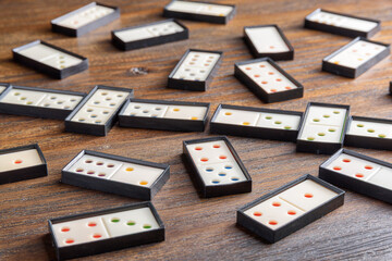 Playing dominoes at a wooden table for fun activity