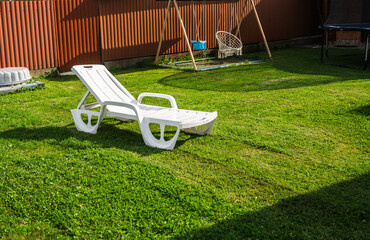 Garden chair at a swimming pool on a hot summer day.