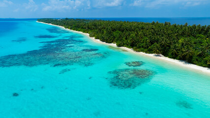 The aerial view in the island with white sand beach as coastline in summer Maldives