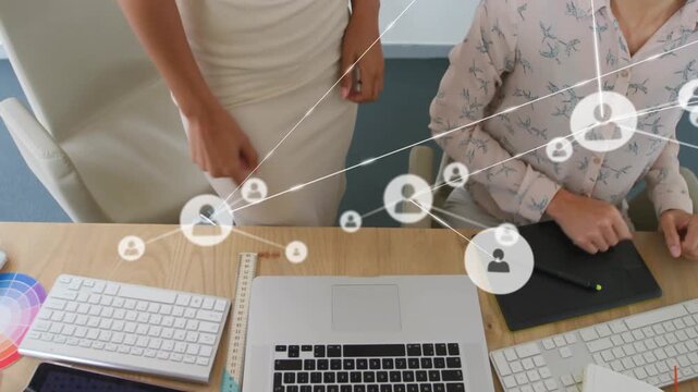 Animation of network of connections with icons over colleagues using computer