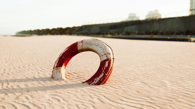A weathered life ring lies partially buried in soft sand as the sun sets, casting long shadows. The tranquil beach scene is serene, with gentle waves lapping nearby, inviting calm reflection.