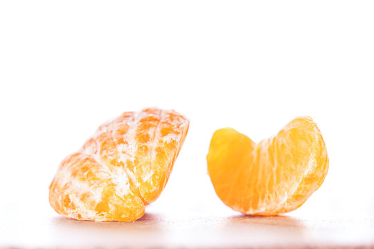 Sliced ​​tangerine on a counter, isolated on a white background