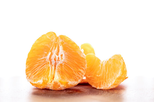 Sliced ​​tangerine on a counter, isolated on a white background