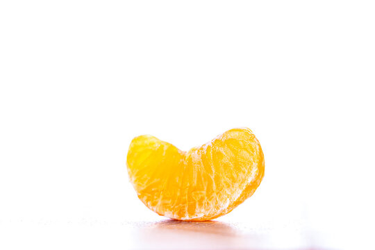 Sliced ​​tangerine on a counter, isolated on a white background