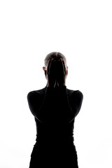Front-facing silhouette of a woman with hands covering her face, set against a white background with copy space