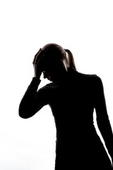 Side-view silhouette of a woman holding her head in apparent distress or deep thought, set against a white background with copy space