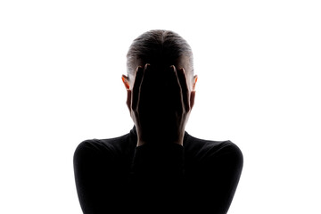 Front-facing silhouette of a woman with hands covering her face, set against a white background with copy space